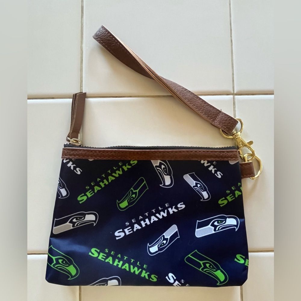 Seahawks wristlet with zipper and detachable wrist strap.